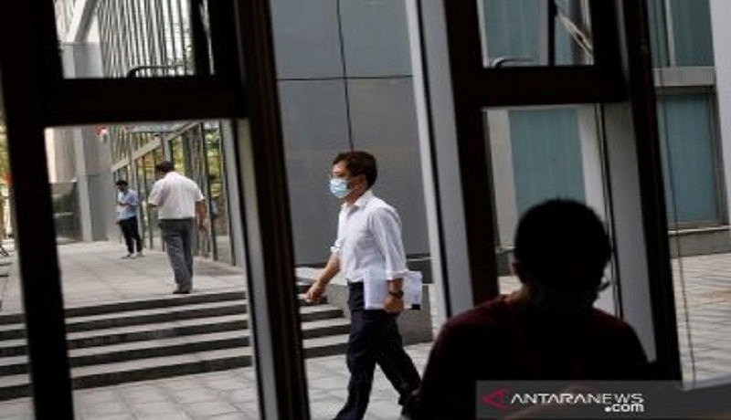 Seorang warga yang memakai masker terlihat melewati Starbucks di Beijing, China. Foto: Antara Seorang warga yang memakai masker terlihat melewati Starbucks di Beijing, China. Foto: Antara
