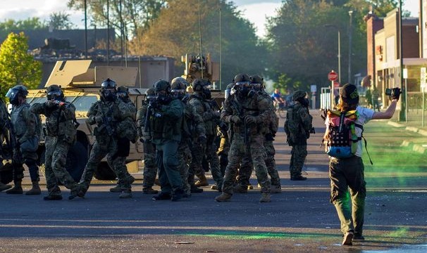 Seorang demonstran akibat kematian George Floyd berhadapan dengan pasukan garda nasional AS di Minneapolis, Minnesota, 29 Mei 2020. (AFP/KEREM YUCEL) Seorang demonstran akibat kematian George Floyd berhadapan dengan pasukan garda nasional AS di Minneapolis, Minnesota, 29 Mei 2020. (AFP/KEREM YUCEL)